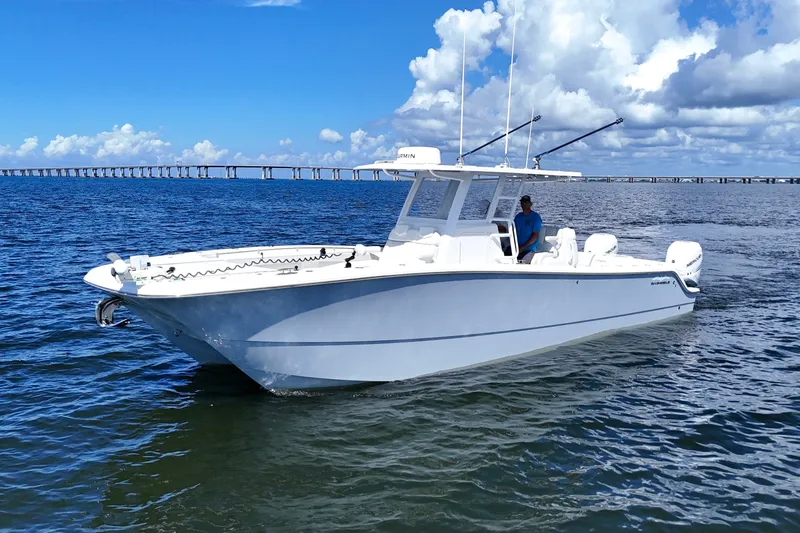Slide: The Image of 2022 Invincible 33 Catamaran on water, clear sky, bridge in background. - 3