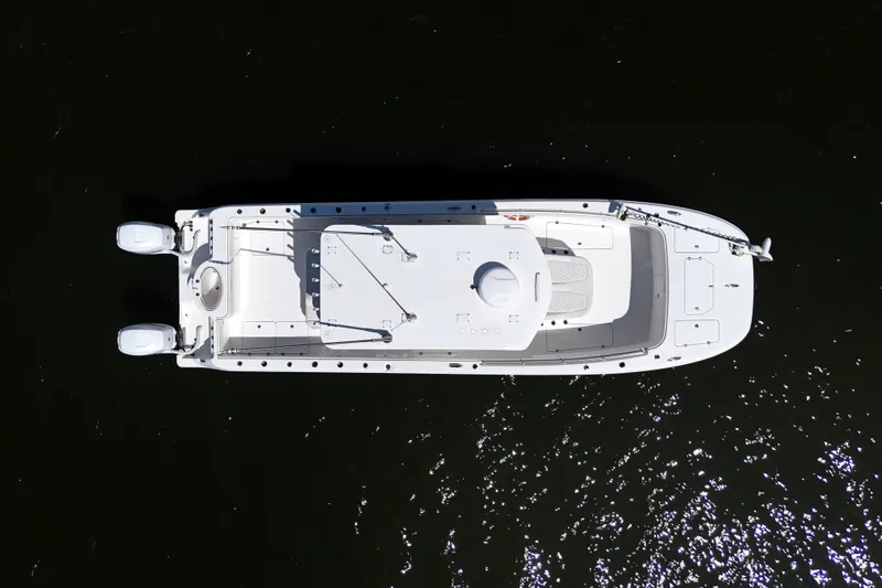 Slide: The Image of Overhead view of 2022 Invincible 33 Catamaran on dark water. - 10