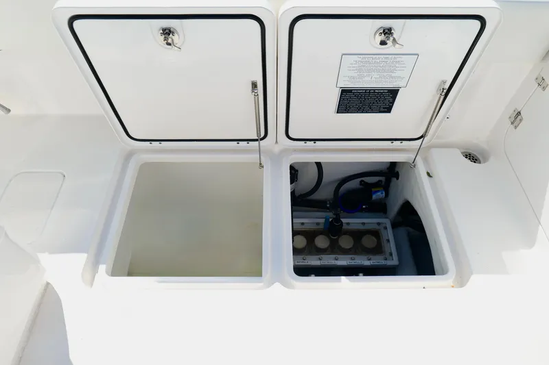 Slide: The Image of Open storage compartments on a 2022 Invincible 33 Catamaran boat. - 29