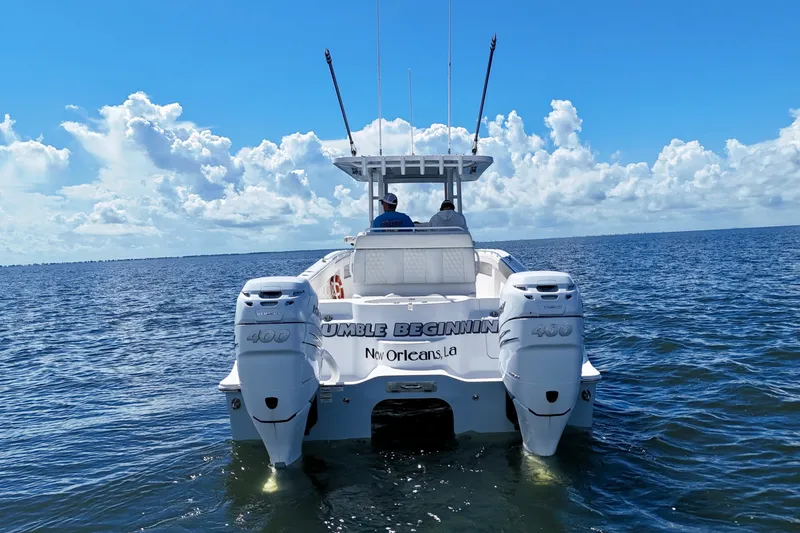 Slide: The Image of 2022 Invincible 33 Catamaran on open water, featuring dual engines and clear skies. - 6
