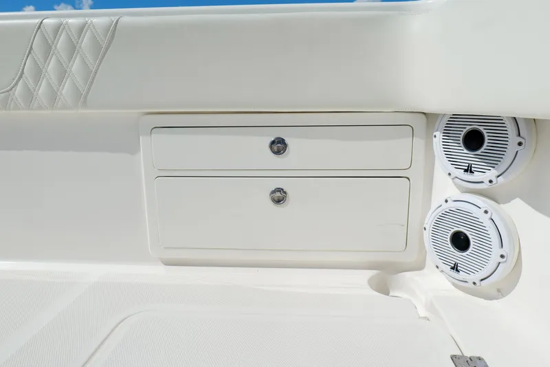 Slide: The Image of 2022 Invincible 33 Catamaran interior with storage compartments and speakers. - 32