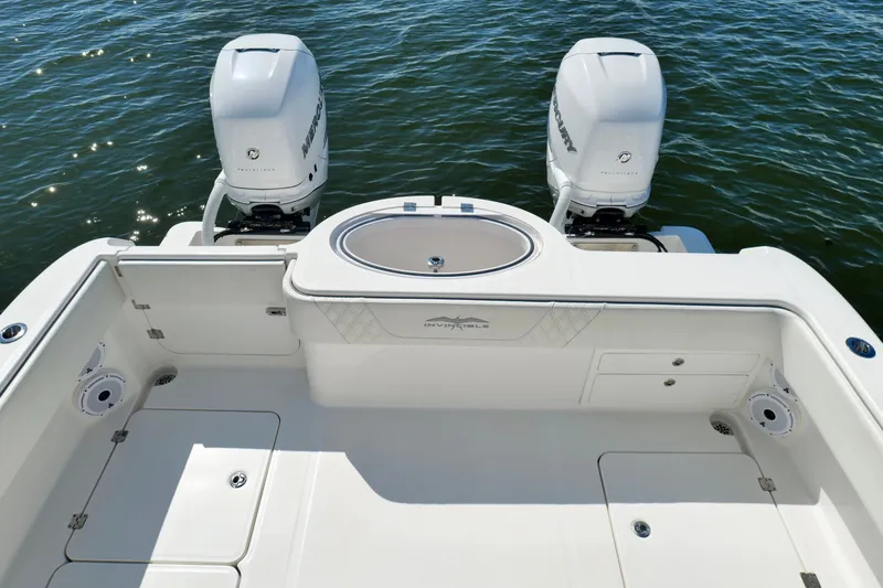 Slide: The Image of 2022 Invincible 33 Catamaran with twin Mercury outboard engines on open water. - 33