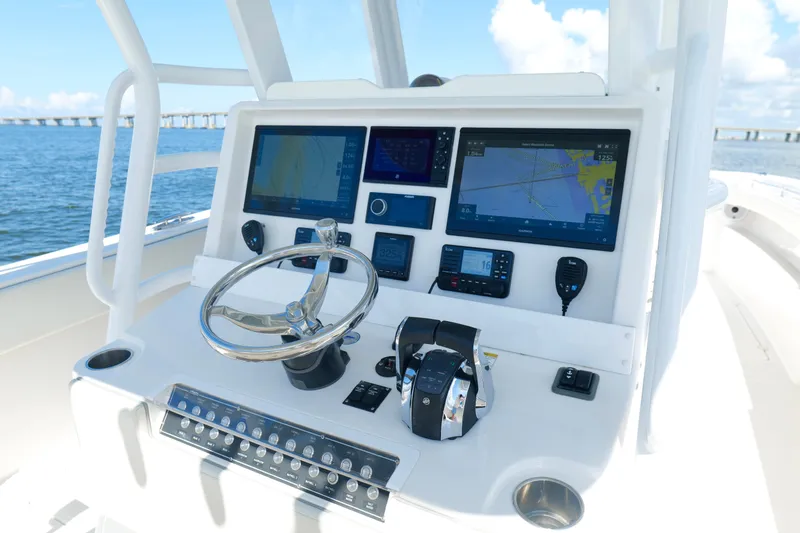 Slide: The Image of Helm of 2022 Invincible 33 Catamaran with advanced navigation displays and controls. - 13