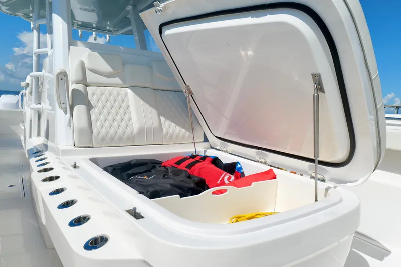 Slide: The Image of 2022 Invincible 33 Catamaran storage compartment with life jackets and seating. - 41