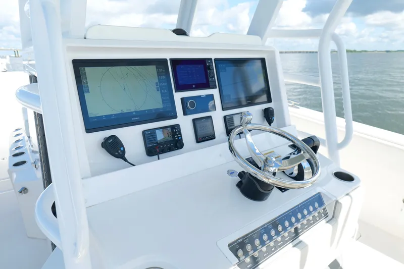 Slide: The Image of Cockpit of 2022 Invincible 33 Catamaran with advanced navigation displays and controls. - 11