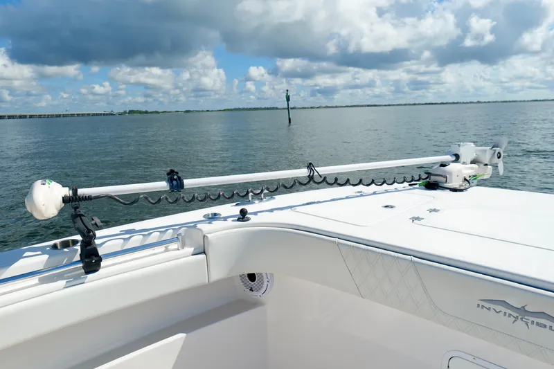Slide: The Image of 2022 Invincible 33 Catamaran on calm waters, featuring advanced fishing equipment. - 45