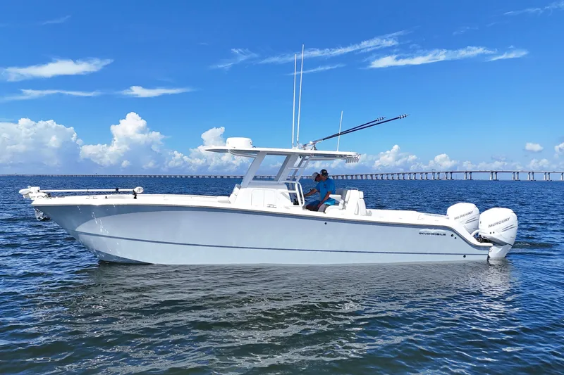 Slide: The Image of 2022 Invincible 33 Catamaran on calm water with clear blue sky background. - 4