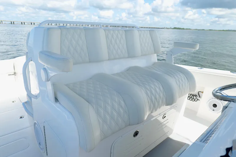 Slide: The Image of Luxurious seating on 2022 Invincible 33 Catamaran, featuring diamond-stitched upholstery. - 16