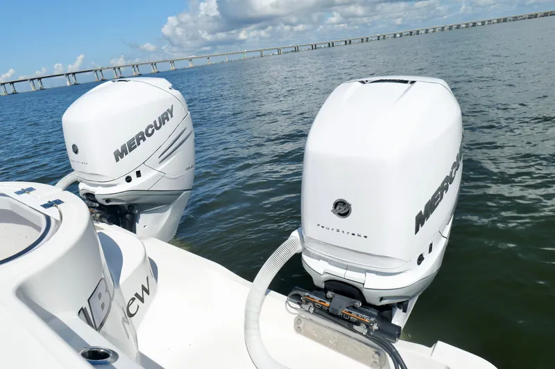 Slide: The Image of 2022 Invincible 33 Catamaran with twin Mercury outboard engines on open water. - 28