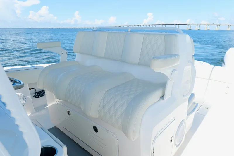 Slide: The Image of Luxurious seating on 2022 Invincible 33 Catamaran, featuring diamond-stitched upholstery and ocean backdrop. - 17