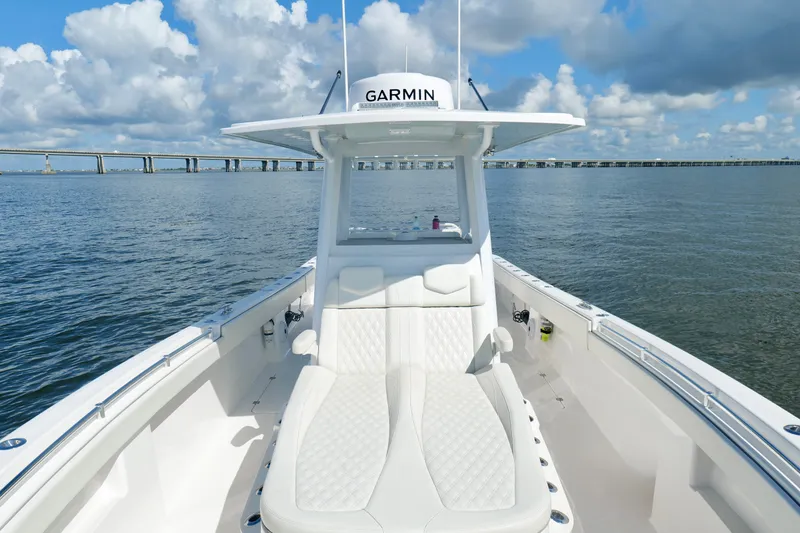 Slide: The Image of 2022 Invincible 33 Catamaran on water, featuring sleek design and comfortable seating. - 38