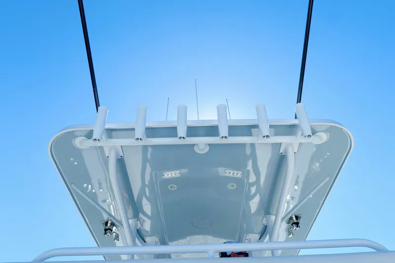 Slide: The Image of Invincible 33 Catamaran 2022, view of the boat's top structure against a clear blue sky. - 19