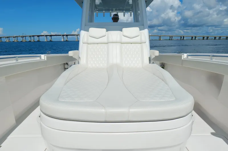 Slide: The Image of Luxurious seating on 2022 Invincible 33 Catamaran with ocean view and bridge in background. - 40