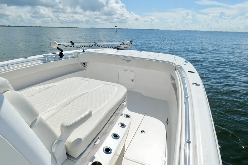 Slide: The Image of 2022 Invincible 33 Catamaran with luxurious seating on calm ocean waters. - 35