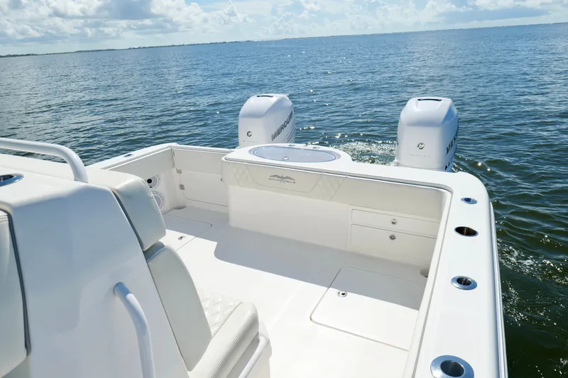 Slide: The Image of 2022 Invincible 33 Catamaran on open water, featuring dual engines and spacious deck. - 22
