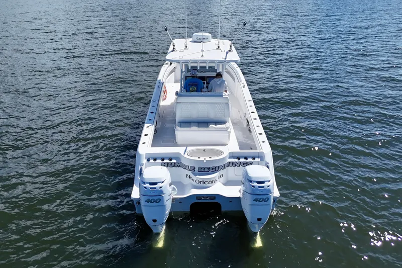 Slide: The Image of 2022 Invincible 33 Catamaran on water, rear view with dual engines. - 8