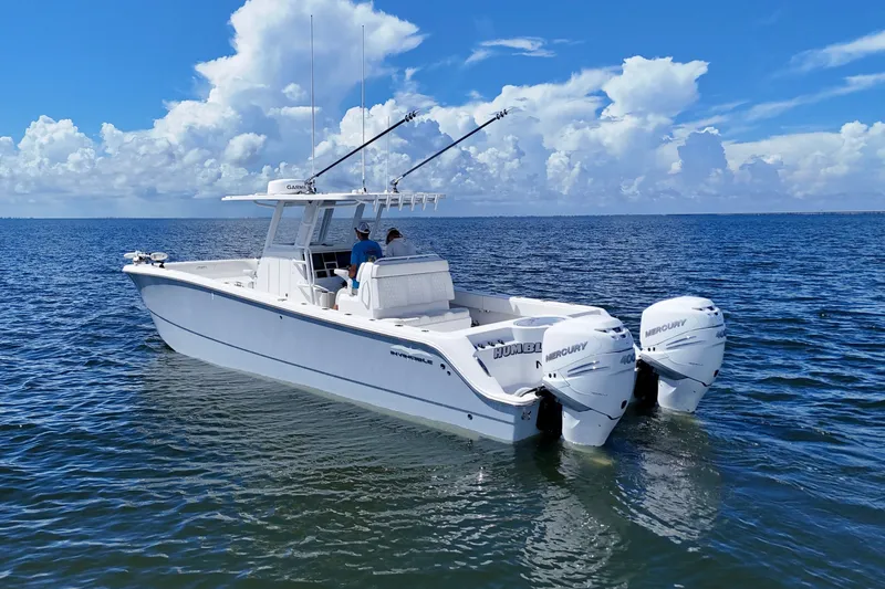 Slide: The Image of 2022 Invincible 33 Catamaran on open water with twin Mercury engines. - 5