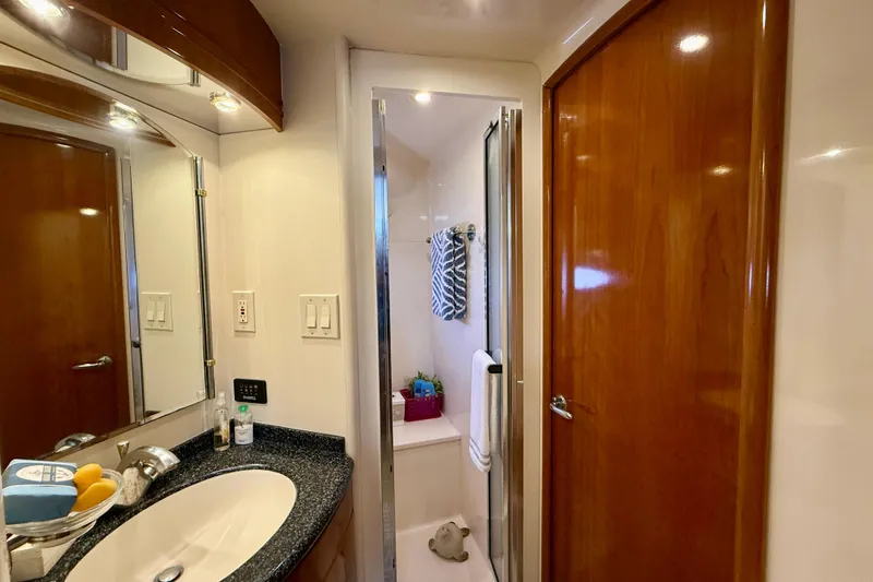 Slide: The Image of Luxurious bathroom interior of 2000 Carver 53 Voyager yacht with sleek wood finishes. - 47
