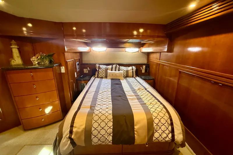 Slide: The Image of Luxurious bedroom interior of 2000 Carver 53 Voyager yacht with elegant wood paneling. - 42