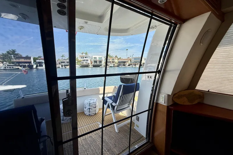 Slide: The Image of Interior view from a 2000 Carver 53 Voyager yacht, overlooking a serene waterfront. - 22