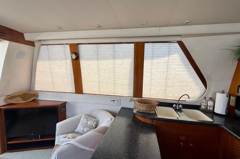 Slide: The Image of Interior of 2000 Carver 53 Voyager yacht with kitchen and seating area. - 17