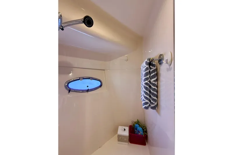 Slide: The Image of Bathroom interior of 2000 Carver 53 Voyager yacht with shower and porthole. - 45