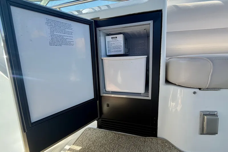 Slide: The Image of Open refrigerator on 2000 Carver 53 Voyager yacht, showing interior storage and seating area. - 86