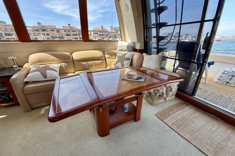 Slide: The Image of Interior of 2000 Carver 53 Voyager yacht with beige sofa and wooden table. - 21