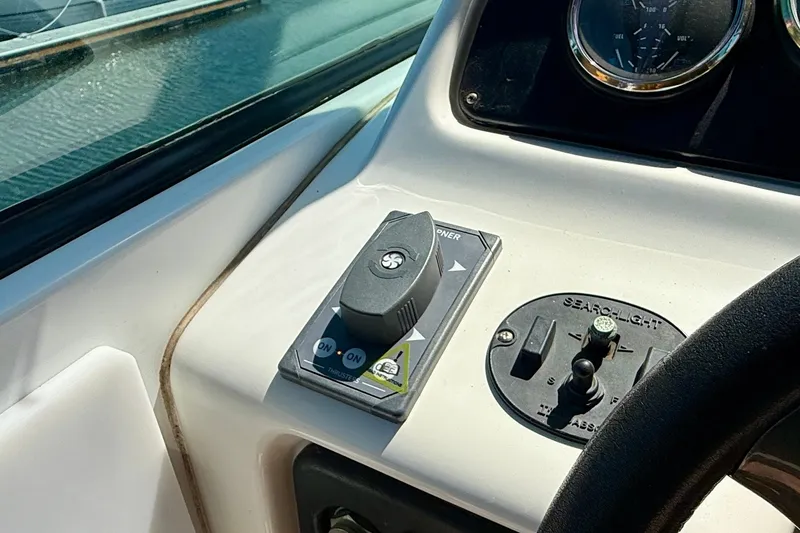 Slide: The Image of Control panel of a 2000 Carver 53 Voyager yacht, featuring navigation and searchlight controls. - 79