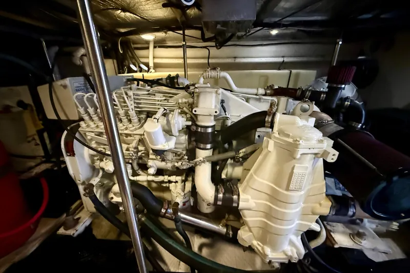 Slide: The Image of Engine room of a 2000 Carver 53 Voyager yacht, showcasing intricate machinery and components. - 98