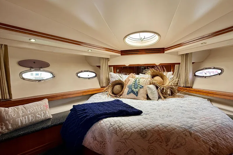 Slide: The Image of Luxurious bedroom interior of 2000 Carver 53 Voyager yacht with cozy bedding and nautical decor. - 39