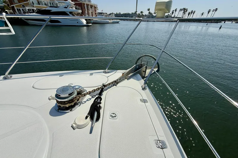 Slide: The Image of Bow of 2000 Carver 53 Voyager yacht with anchor chain, docked in marina. - 87