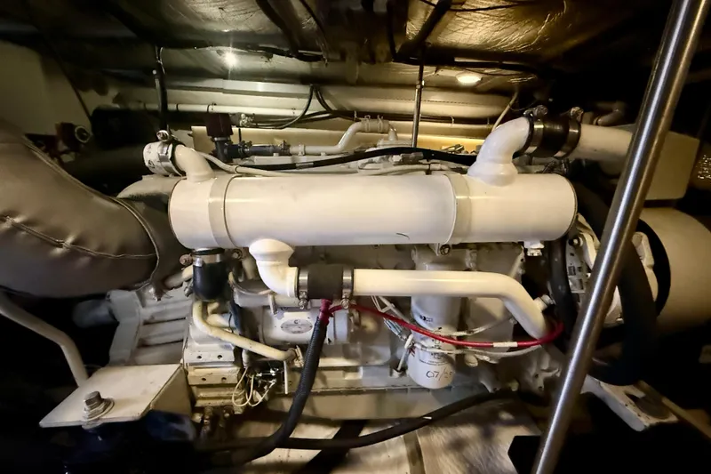 Slide: The Image of Engine room of a 2000 Carver 53 Voyager yacht, showcasing mechanical components. - 100