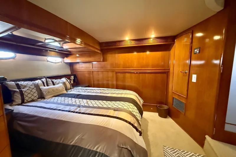Slide: The Image of Luxurious bedroom interior of 2000 Carver 53 Voyager yacht with elegant wood paneling. - 44