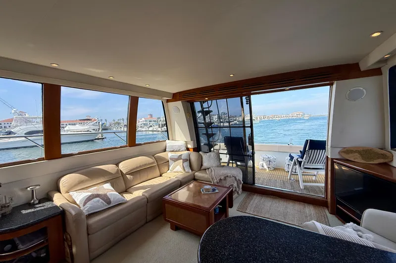 Slide: The Image of Luxurious interior of 2000 Carver 53 Voyager yacht with ocean view and comfortable seating. - 15