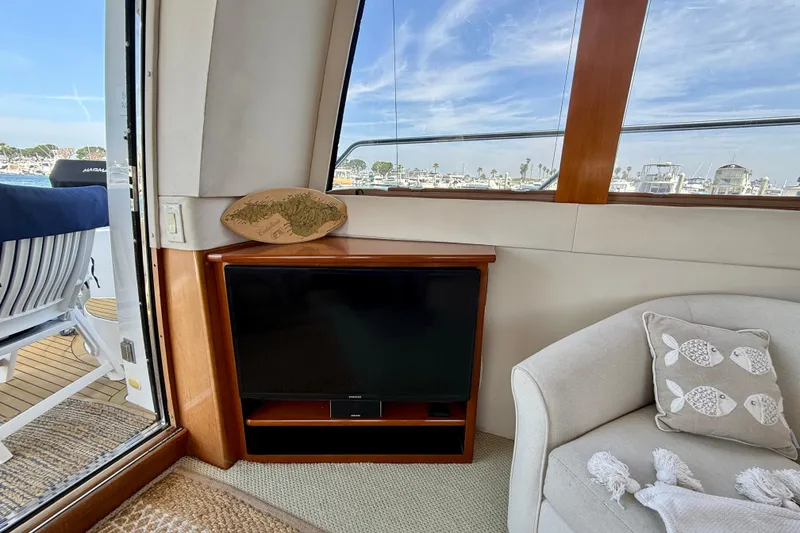 Slide: The Image of Interior of 2000 Carver 53 Voyager yacht with TV, chair, and ocean view. - 16