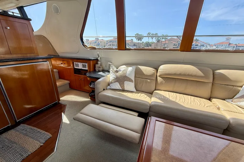 Slide: The Image of Luxurious interior of 2000 Carver 53 Voyager yacht with leather seating and wooden cabinetry. - 19