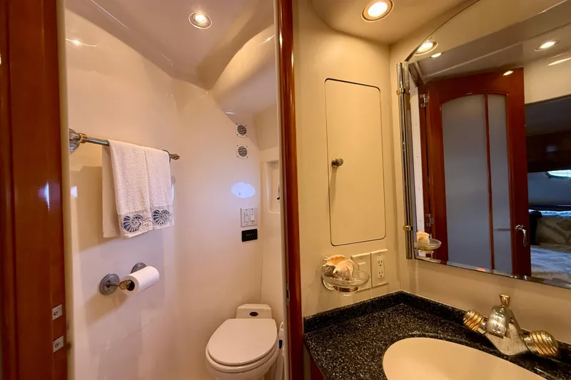 Slide: The Image of Luxurious bathroom in a 2000 Carver 53 Voyager yacht, featuring elegant fixtures and lighting. - 52