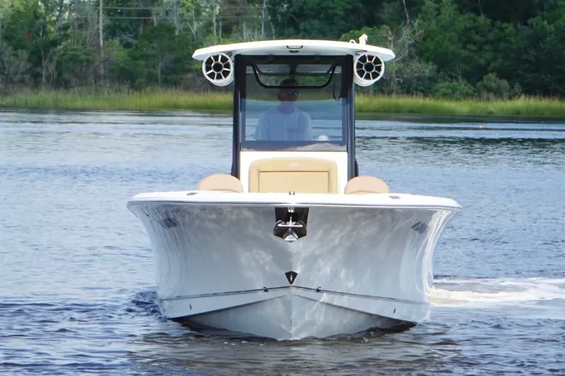 Slide: The Image of 2021 Sea Hunt Gamefish 27FS boat cruising on a calm lake. - 6