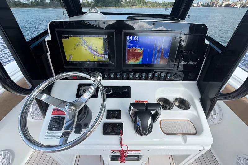 Slide: The Image of 2021 Sea Hunt Gamefish 27FS helm with navigation screens and controls. - 10