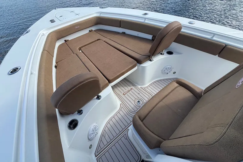 Slide: The Image of 2021 Sea Hunt Gamefish 27FS boat interior with brown cushioned seating. - 13