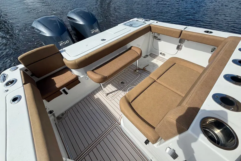 Slide: The Image of 2021 Sea Hunt Gamefish 27FS boat interior with seating and twin Yamaha 250 engines. - 18