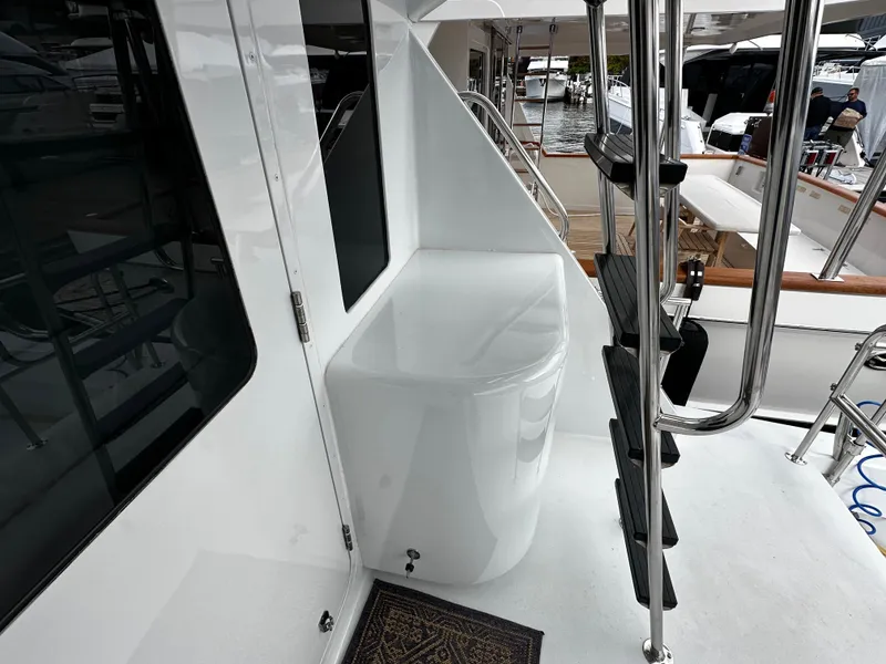 Slide: The Image of The 2000 Hatteras 70 Convertible features a clean, white exterior staircase and a glossy surface. - 29