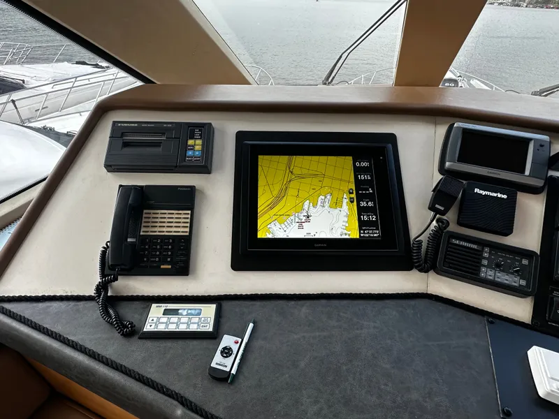 Slide: The Image of The image shows the helm of a Hatteras 70 Convertible with navigation system and communication devices. - 38