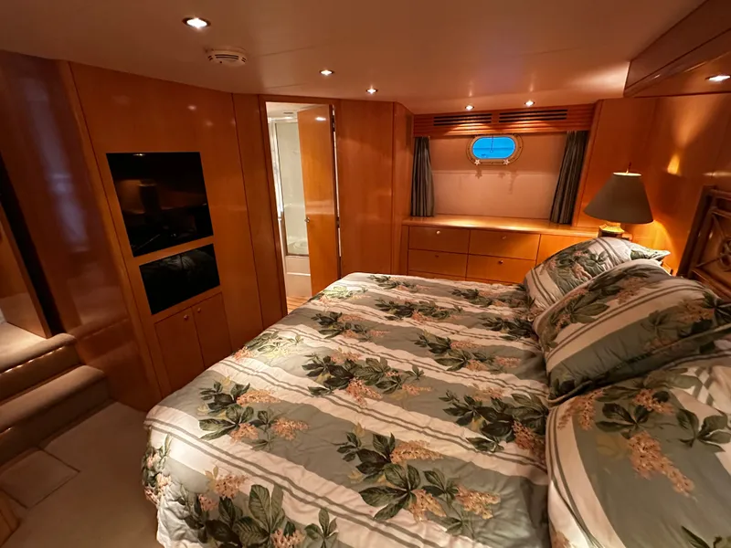 Slide: The Image of Luxurious bedroom with wood paneling, a large bed with patterned bedding, and a small window. - 19