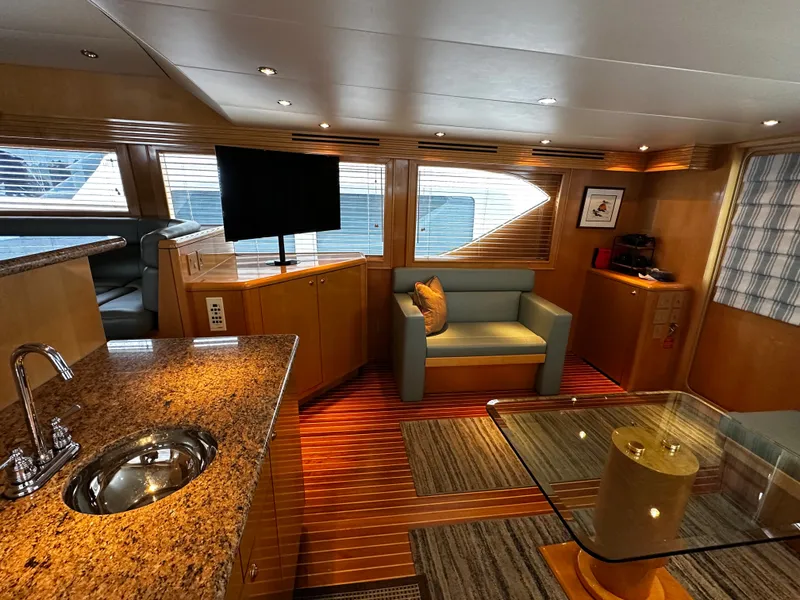 Slide: The Image of Interior of a 2000 Hatteras 70 Convertible with elegant furnishings and modern amenities. - 9