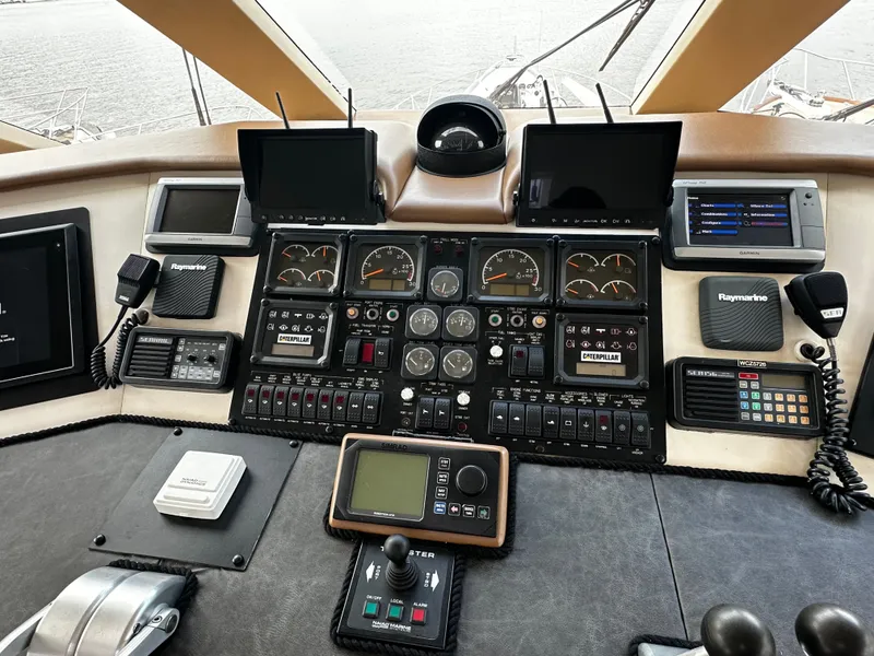 Slide: The Image of The cockpit of the 2000 Hatteras 70 Convertible features a variety of instruments and screens. - 37