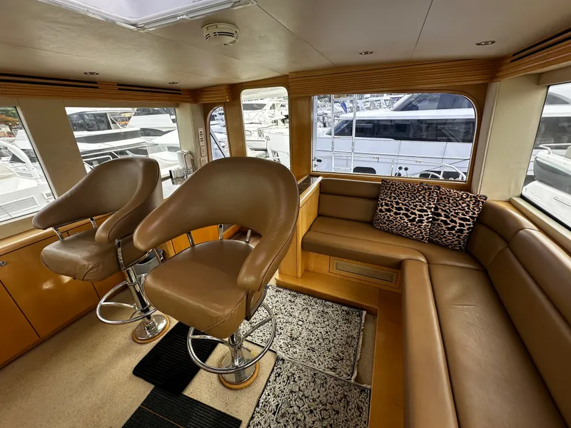 Slide: The Image of Interior of a 2000 Hatteras 70 Convertible with leather seating and large windows. - 40