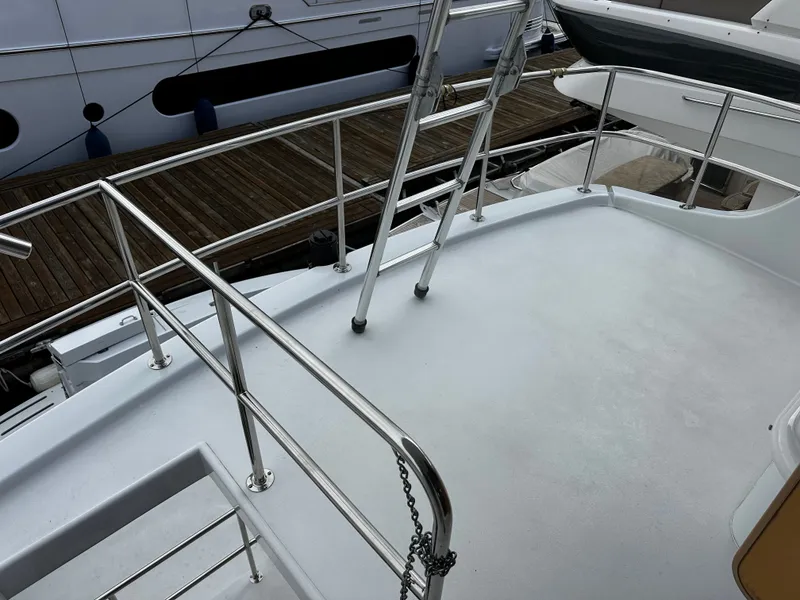 Slide: The Image of The image shows the deck of a 2000 Hatteras 70 Convertible with stainless steel railings. - 33