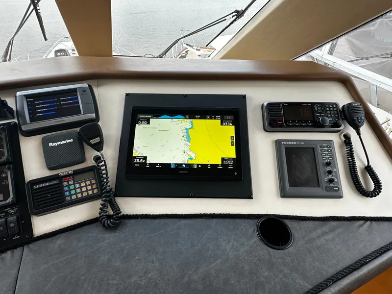 Slide: The Image of The image shows the helm of a Hatteras 70 Convertible with navigation equipment and radio. - 36